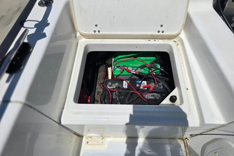 Slide: The Image of Battery compartment of a 2017 Boston Whaler 210 Montauk boat, showing wiring and connections. - 28