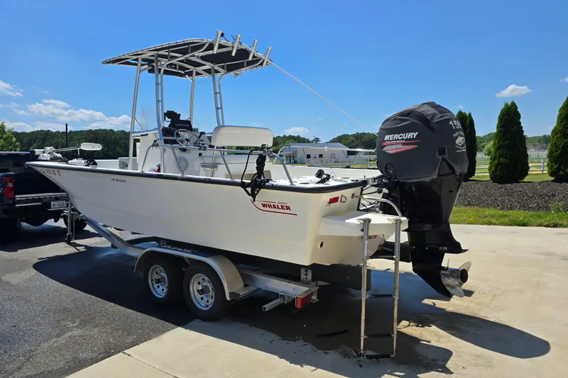 Slide: The Image of 2017 Boston Whaler 210 Montauk boat on trailer with Mercury outboard motor. - 34