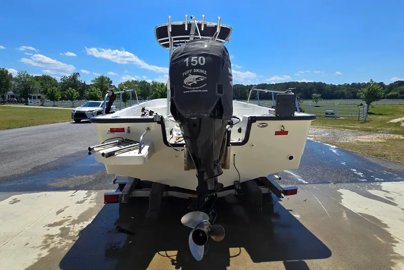 Slide: The Image of 2017 Boston Whaler 210 Montauk boat with outboard motor on trailer, sunny day. - 5