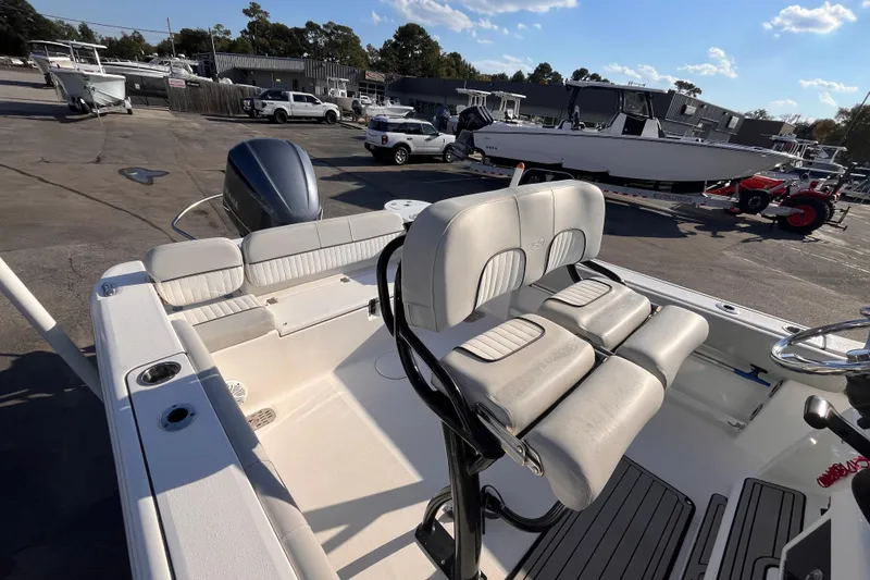 Slide: The Image of 2020 Sea Fox 248 Commander boat interior with seating and steering wheel, parked outdoors. - 10