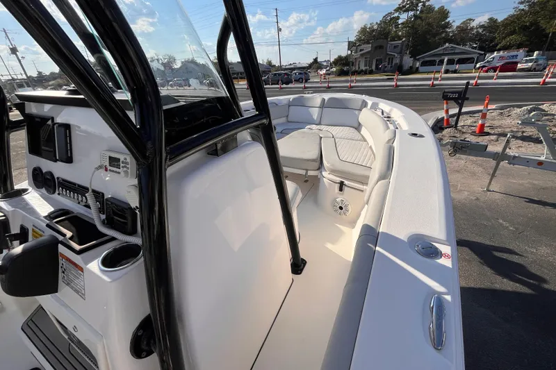 Slide: The Image of 2020 Sea Fox 248 Commander boat interior with seating and control panel, parked outdoors. - 12