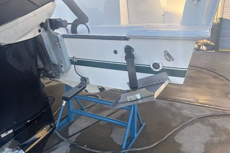 Slide: The Image of 1999 Contender 23 Open boat on stand, showing motor and hull details. - 10