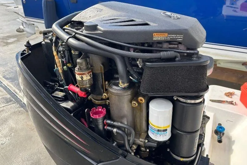 Slide: The Image of Close-up of a 1999 Contender 23 Open boat engine, showcasing detailed components. - 13