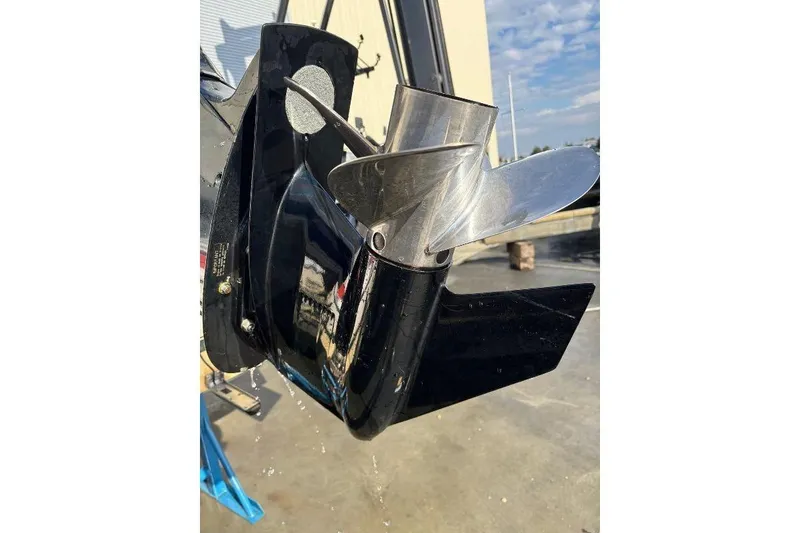 Slide: The Image of Close-up of a 1999 Contender 23 Open boat propeller in a sunny outdoor setting. - 14