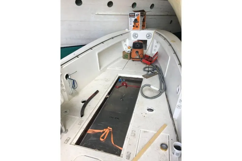 Slide: The Image of 1999 Contender 23 Open boat interior with tools and equipment on deck. - 21