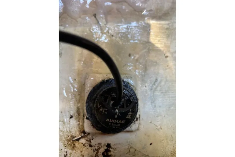 Slide: The Image of Close-up of Airmar transducer on 1999 Contender 23 Open boat. - 23