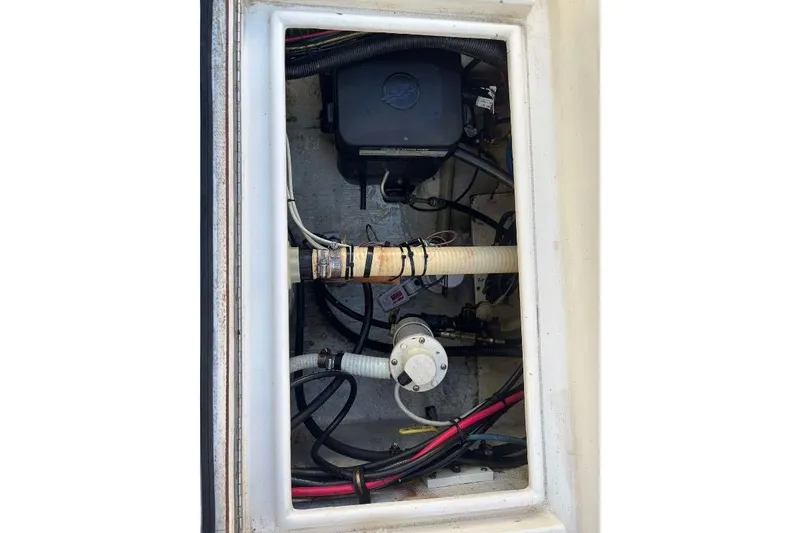 Slide: The Image of 1999 Contender 23 Open boat compartment with wiring and mechanical components. - 24