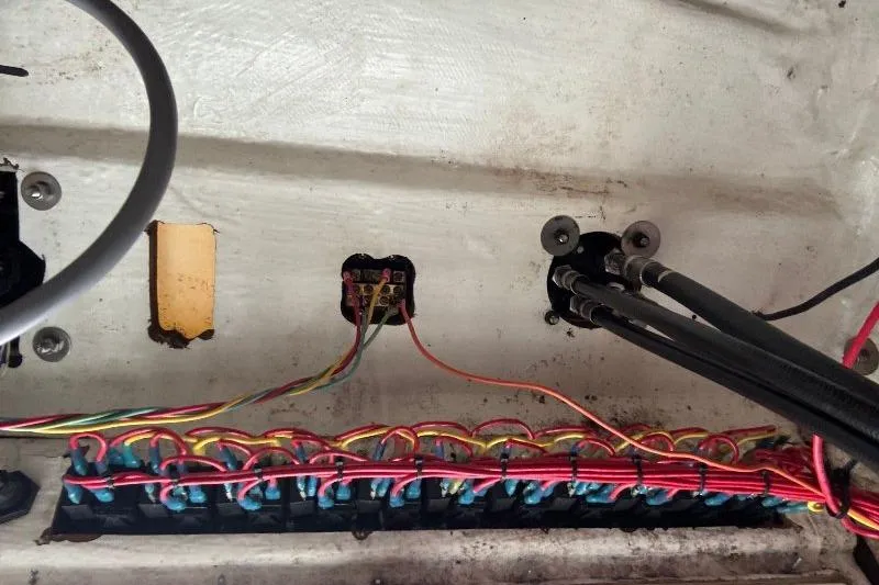 Slide: The Image of Wiring and cables inside a 1999 Contender 23 Open boat, showcasing electrical connections. - 25