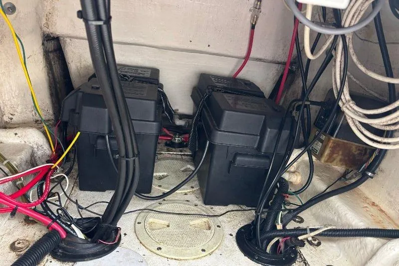 Slide: The Image of Battery compartment of a 1999 Contender 23 Open boat with wiring and connections. - 26