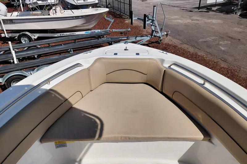 Slide: The Image of 2020 NauticStar 20 XS boat with beige cushioned seating and trailer in background. - 15