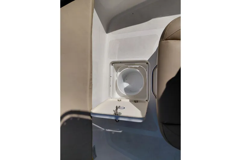 Slide: The Image of 2020 NauticStar 20 XS boat interior with open storage compartment and seating. - 16