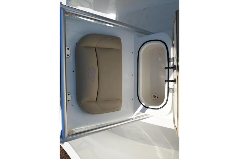 Slide: The Image of 2020 NauticStar 20 XS boat interior with beige seating and storage compartment. - 17