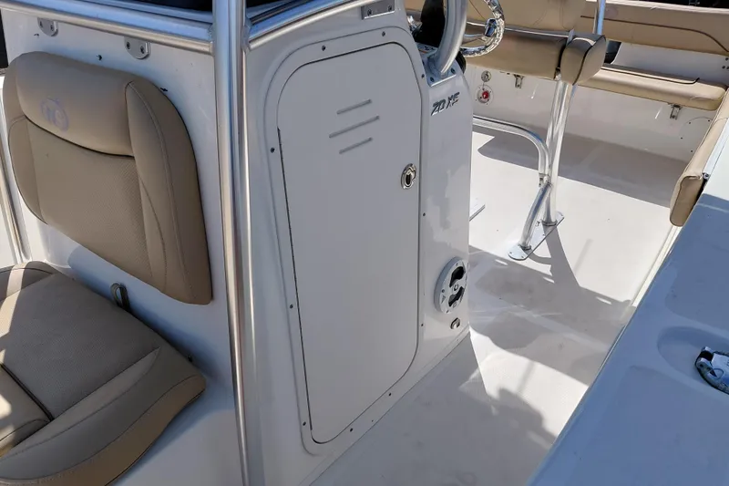 Slide: The Image of 2020 NauticStar 20 XS boat interior with beige seating and steering console. - 20