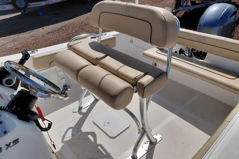 Slide: The Image of 2020 NauticStar 20 XS boat interior with beige seating and steering wheel. - 23