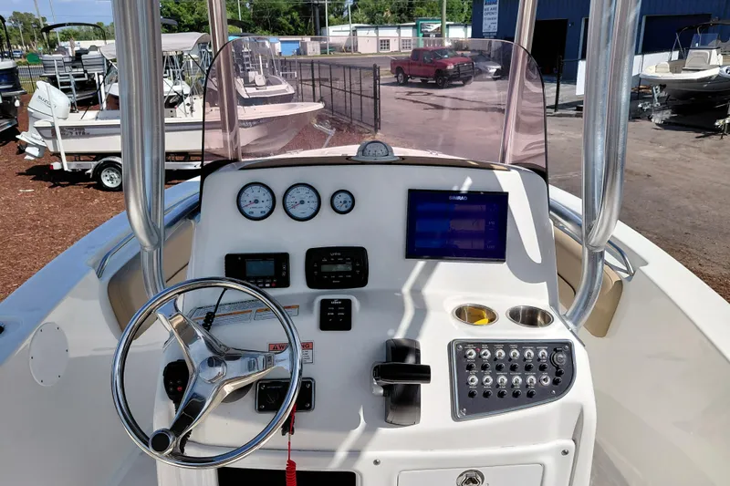 Slide: The Image of 2020 NauticStar 20 XS boat dashboard with steering wheel, gauges, and navigation display. - 24