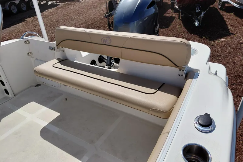 Slide: The Image of 2020 NauticStar 20 XS boat interior with beige seating and cup holders. - 27
