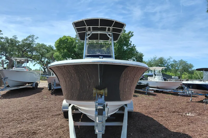 Slide: The Image of 2020 NauticStar 20 XS boat on trailer, surrounded by trees and other boats. - 3