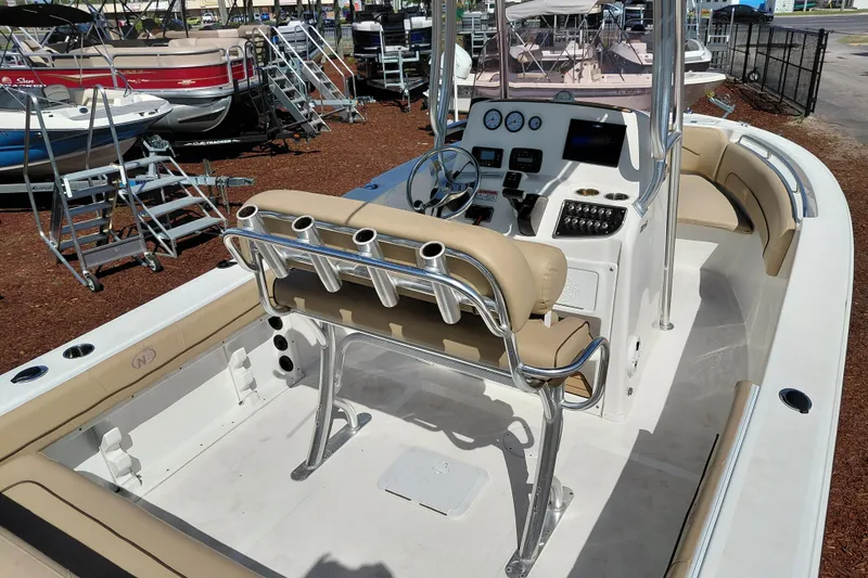 Slide: The Image of 2020 NauticStar 20 XS boat interior with beige seating and modern dashboard controls. - 32