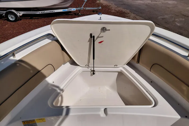 Slide: The Image of Open storage compartment on 2020 NauticStar 20 XS boat, featuring beige seating. - 34