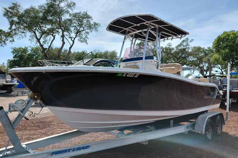 Slide: The Image of 2020 NauticStar 20 XS boat on trailer, parked outdoors under clear sky. - 4