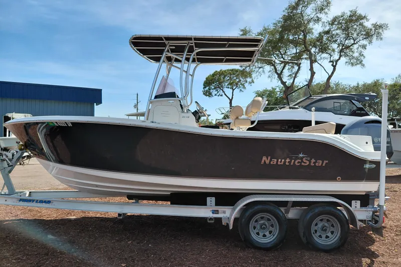 Slide: The Image of 2020 NauticStar 20 XS boat on trailer, parked outdoors under clear sky. - 5