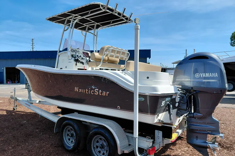 Slide: The Image of 2020 NauticStar 20 XS boat with Yamaha engine on trailer, parked outdoors. - 7