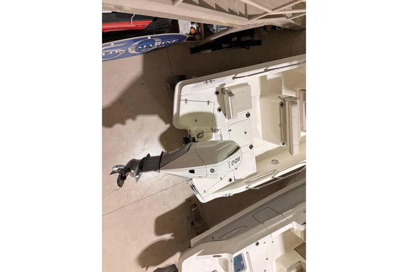 Slide: The Image of 2026 Boston Whaler 250 Dauntless boat with outboard motor, viewed from above in showroom. - 4