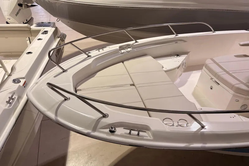 Slide: The Image of 2026 Boston Whaler 250 Dauntless boat interior with cushioned seating and stainless steel railings. - 5