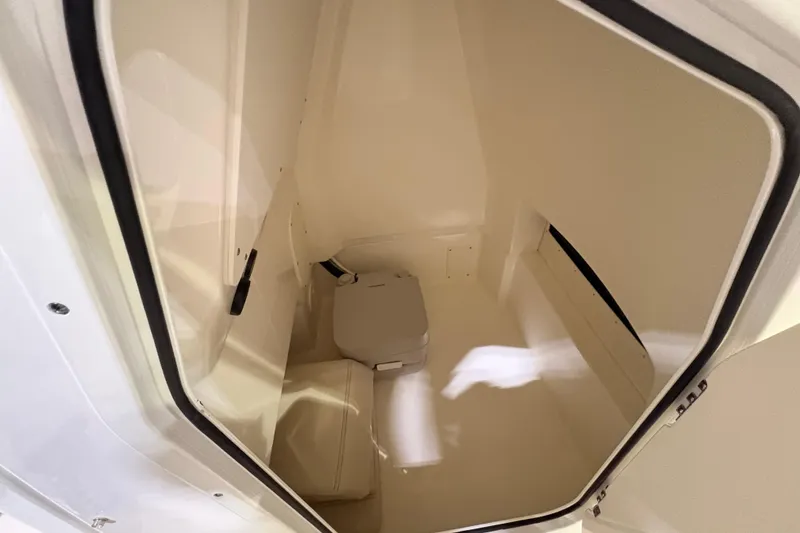 Slide: The Image of Interior cabin of 2026 Boston Whaler 250 Dauntless boat, featuring compact seating. - 6