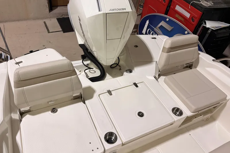 Slide: The Image of 2026 Boston Whaler 250 Dauntless boat interior with Mercury engine and seating area. - 7