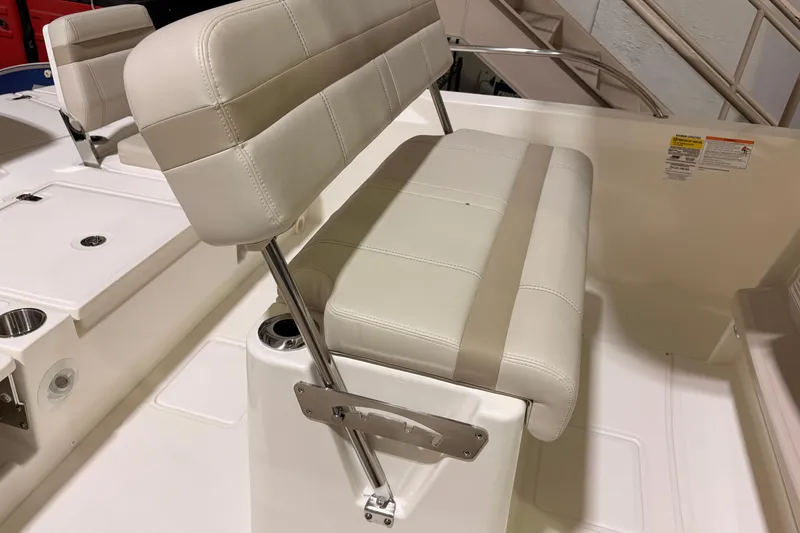 Slide: The Image of 2026 Boston Whaler 250 Dauntless boat seat with white upholstery and stainless steel frame. - 9