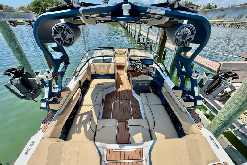 Slide: The Image of 2021 Nautique Super Air Nautique G21 boat interior with luxurious seating and advanced audio system. - 12