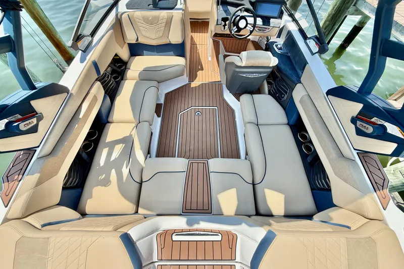 Slide: The Image of Interior of 2021 Nautique Super Air Nautique G21 boat with luxurious seating and wood accents. - 13