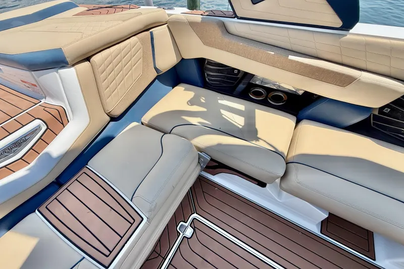 Slide: The Image of Luxurious interior of 2021 Nautique Super Air Nautique G21 boat with tan seating. - 14