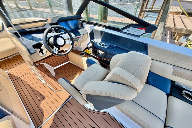 Slide: The Image of 2021 Nautique Super Air Nautique G21 interior with modern helm and luxurious seating. - 16