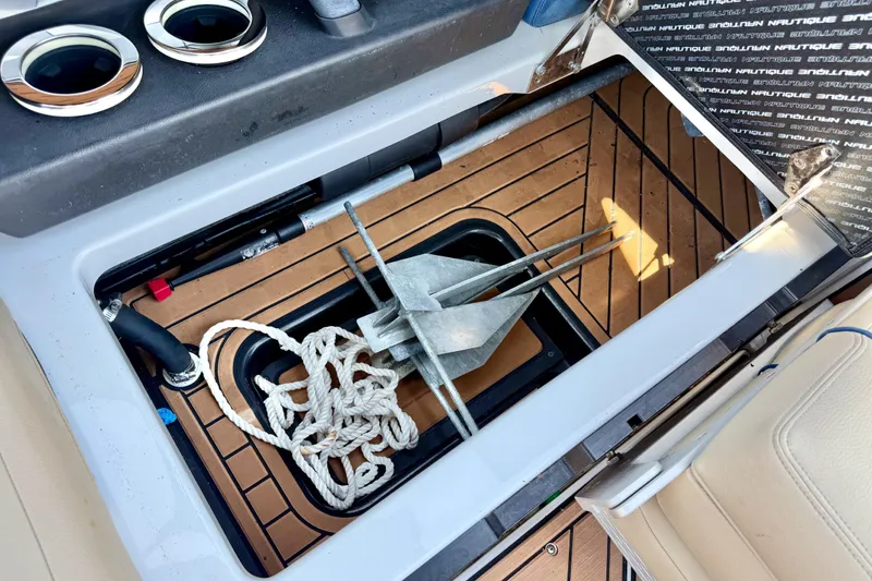 Slide: The Image of Storage compartment of 2021 Nautique Super Air Nautique G21 with anchor and rope. - 18