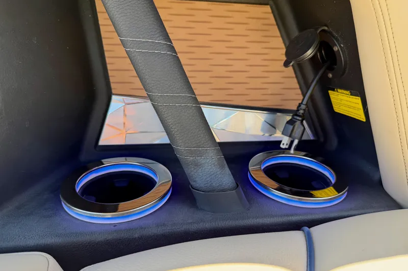 Slide: The Image of 2021 Nautique Super Air Nautique G21 interior cup holders with blue LED lighting. - 25