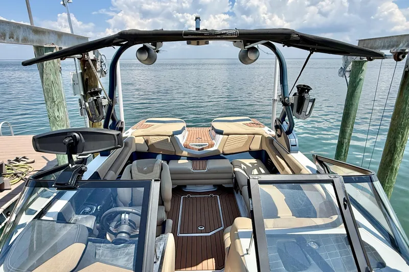 Slide: The Image of 2021 Nautique Super Air Nautique G21 boat interior with seating and water view. - 26