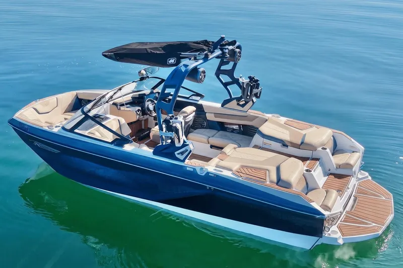 Slide: The Image of 2021 Nautique Super Air Nautique G21 boat on calm blue water. - 3