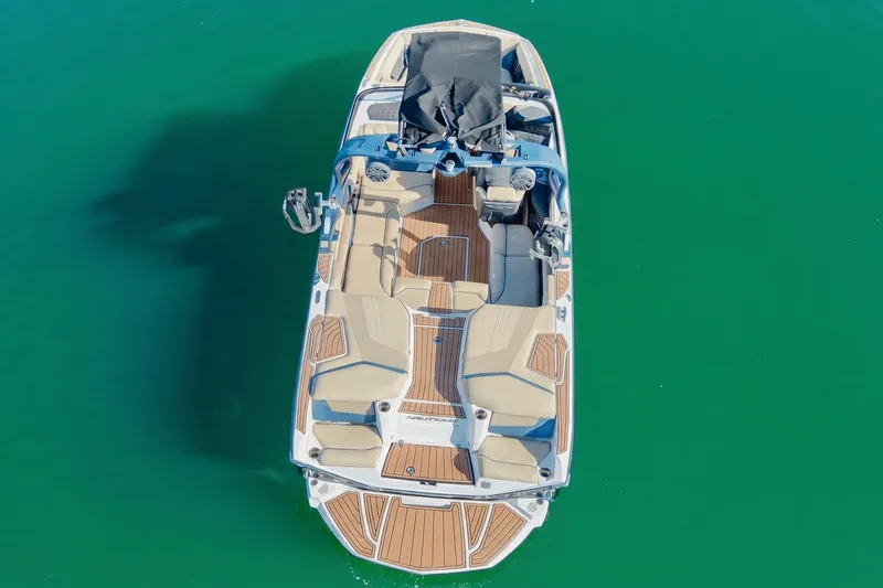 Slide: The Image of 2021 Nautique Super Air Nautique G21 boat on clear green water, aerial view. - 4