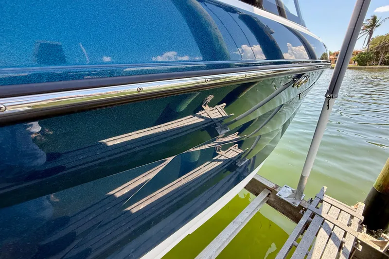 Slide: The Image of 2021 Nautique Super Air Nautique G21 boat hull reflecting water and dock. - 5