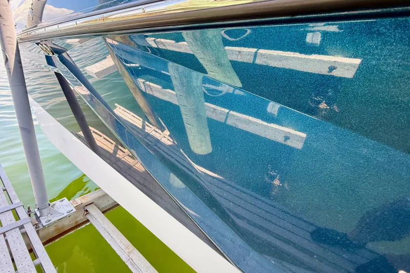 Slide: The Image of 2021 Nautique Super Air Nautique G21 boat hull reflecting dock and water. - 8