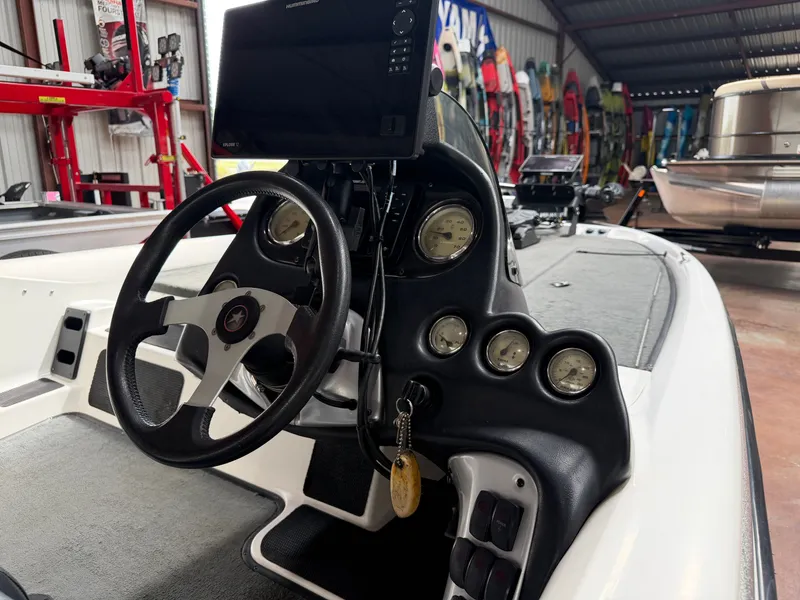 Slide: The Image of Interior view of a 2005 Stratos 294 Pro XL boat with controls. - 14