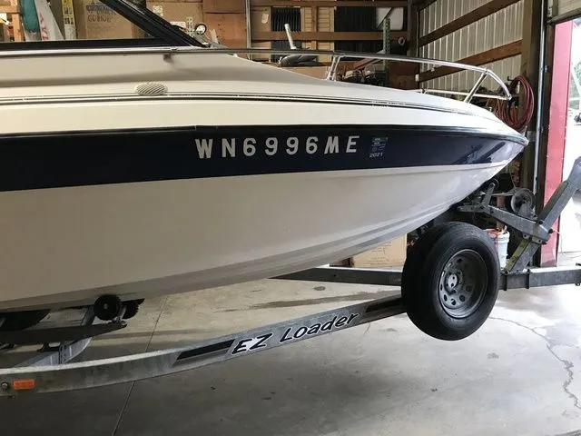 Slide: The Image of 1994 Livingston Viking boat on EZ Loader trailer in garage. - 5