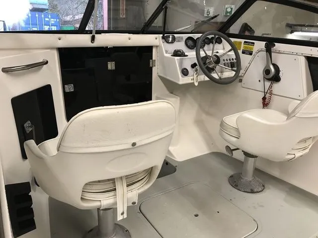 Slide: The Image of Interior of a 1994 Livingston Viking boat with white seats. - 7