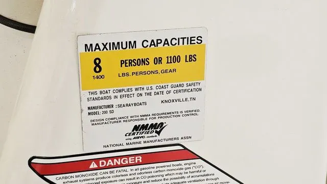 Slide: The Image of Safety label on 2012 Sea Ray 200 Sundeck showing capacity and warning information. - 25
