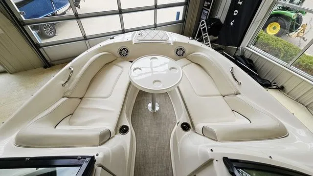 Slide: The Image of Interior view of a 2012 Sea Ray 200 Sundeck with seating and table. - 14