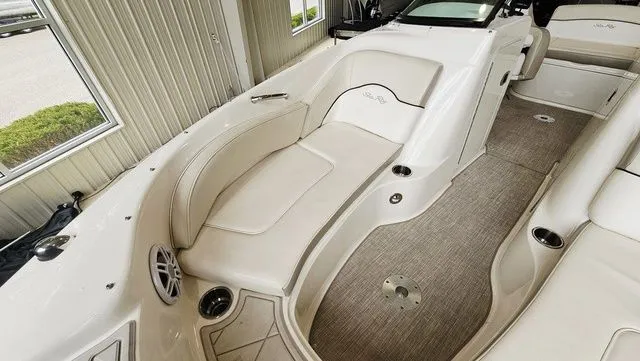 Slide: The Image of Interior of a 2012 Sea Ray 200 Sundeck boat with beige seating. - 16