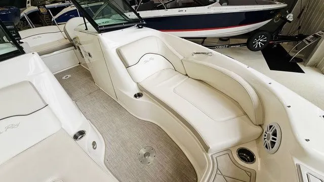 Slide: The Image of Interior of a 2012 Sea Ray 200 Sundeck with beige upholstery. - 17