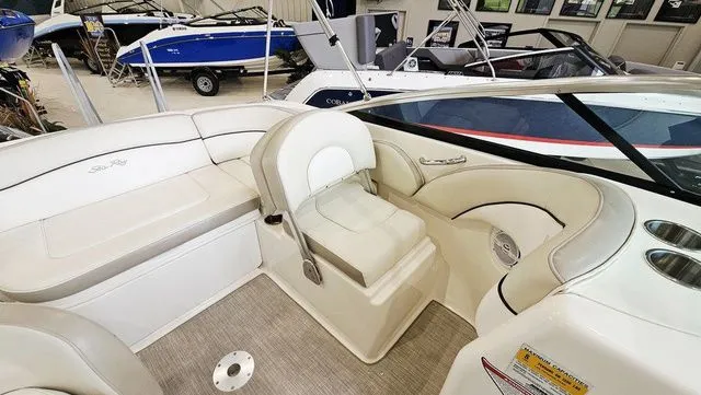 Slide: The Image of Interior of a 2012 Sea Ray 200 Sundeck boat with white seating. - 9